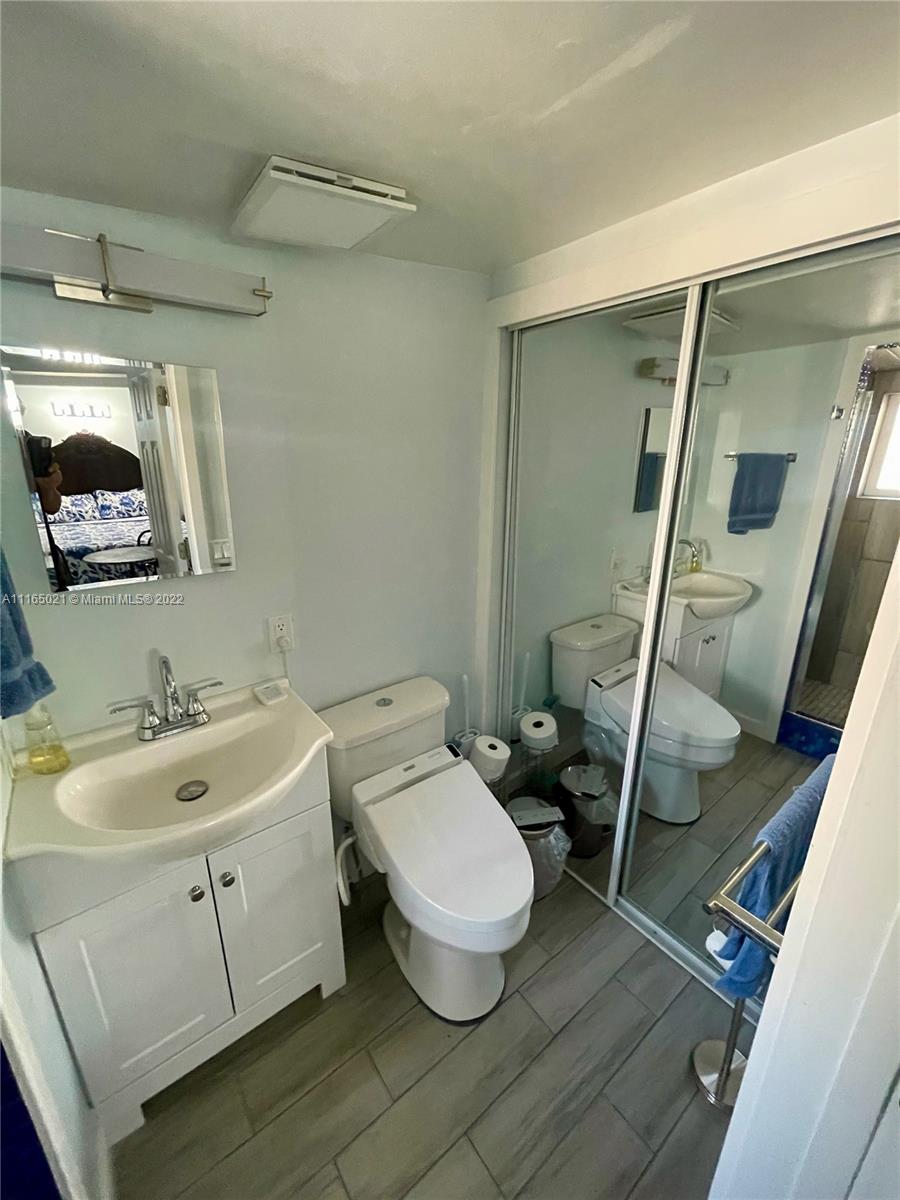 3 Sunset Lane Lauderdale-by-the-Sea, FL 33062 - Photo 21 of 36 a bathroom with a toilet sink and mirror