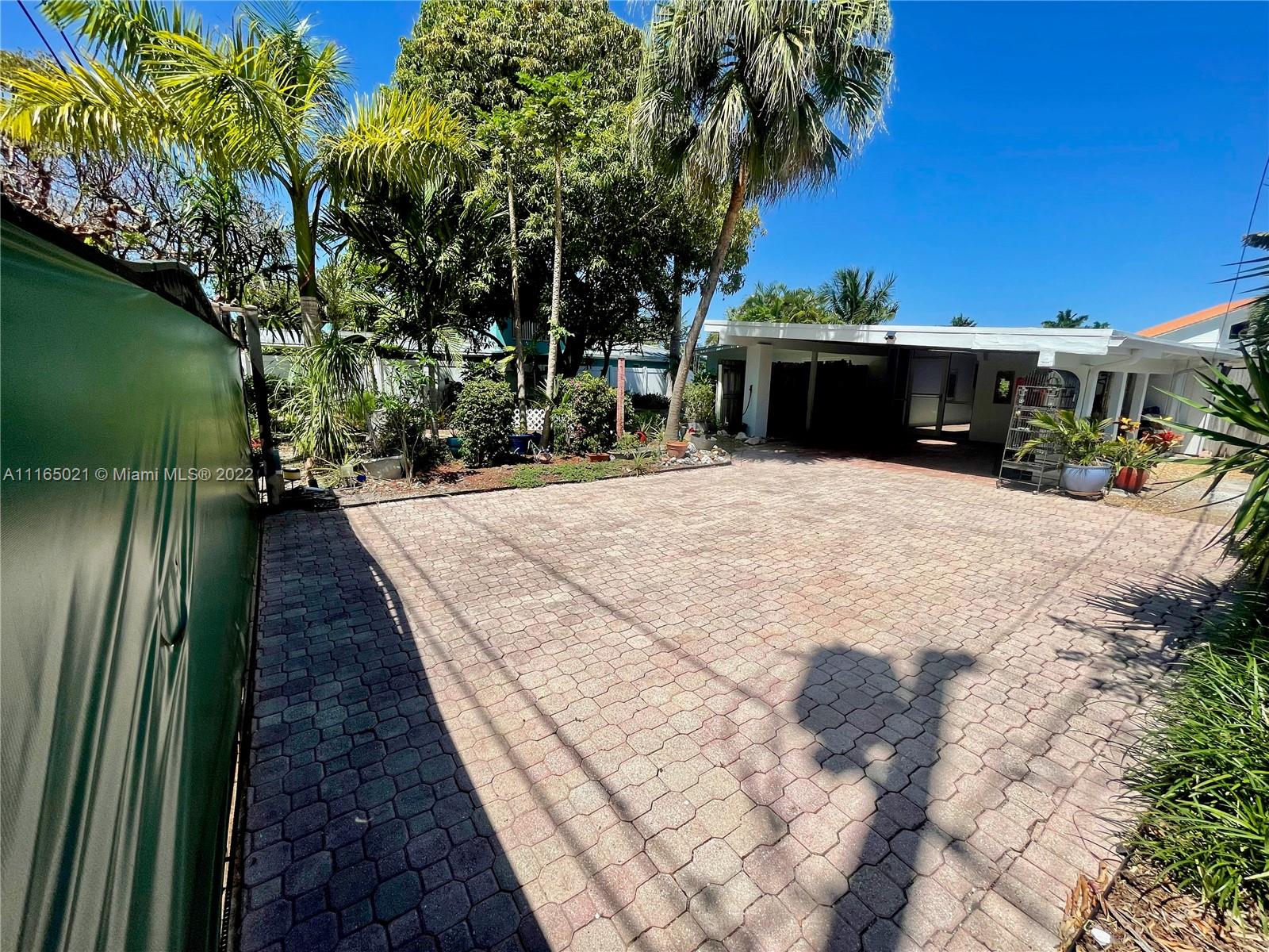 3 Sunset Lane Lauderdale-by-the-Sea, FL 33062 - Photo 25 of 36 a view of a backyard with sitting area