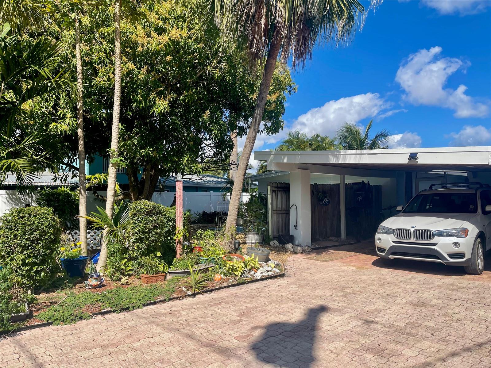 3 Sunset Lane Lauderdale-by-the-Sea, FL 33062 - Photo 26 of 36 a car parked in front of white house