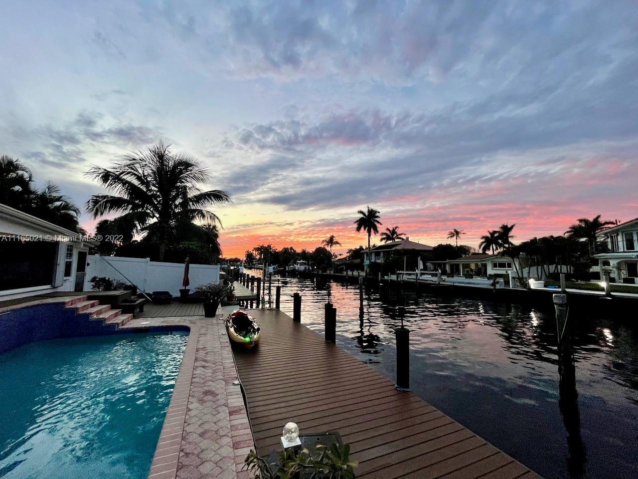 3 Sunset Lane Lauderdale-by-the-Sea, FL 33062 - Photo 3 of 36 a view of a lake with boats and trees in the background