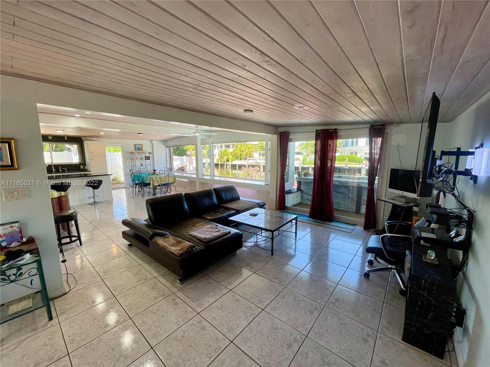 3 Sunset Lane Lauderdale-by-the-Sea, FL 33062 - Photo 8 of 36 a living room with furniture and a large window