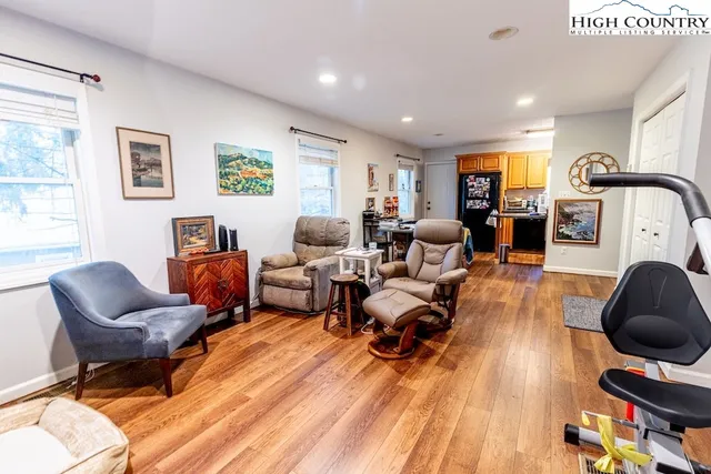 a living room with furniture and a wooden floor