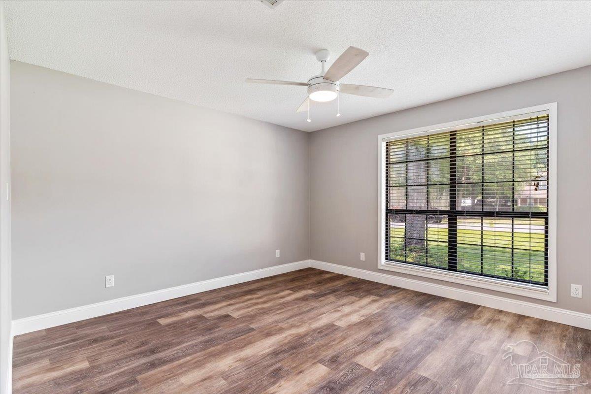 2787 Willow Bend Court Crestview, FL 32539 - Photo 12 of 46 an empty room with wooden floor fan and windows