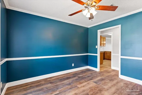 an empty room with closet and fan