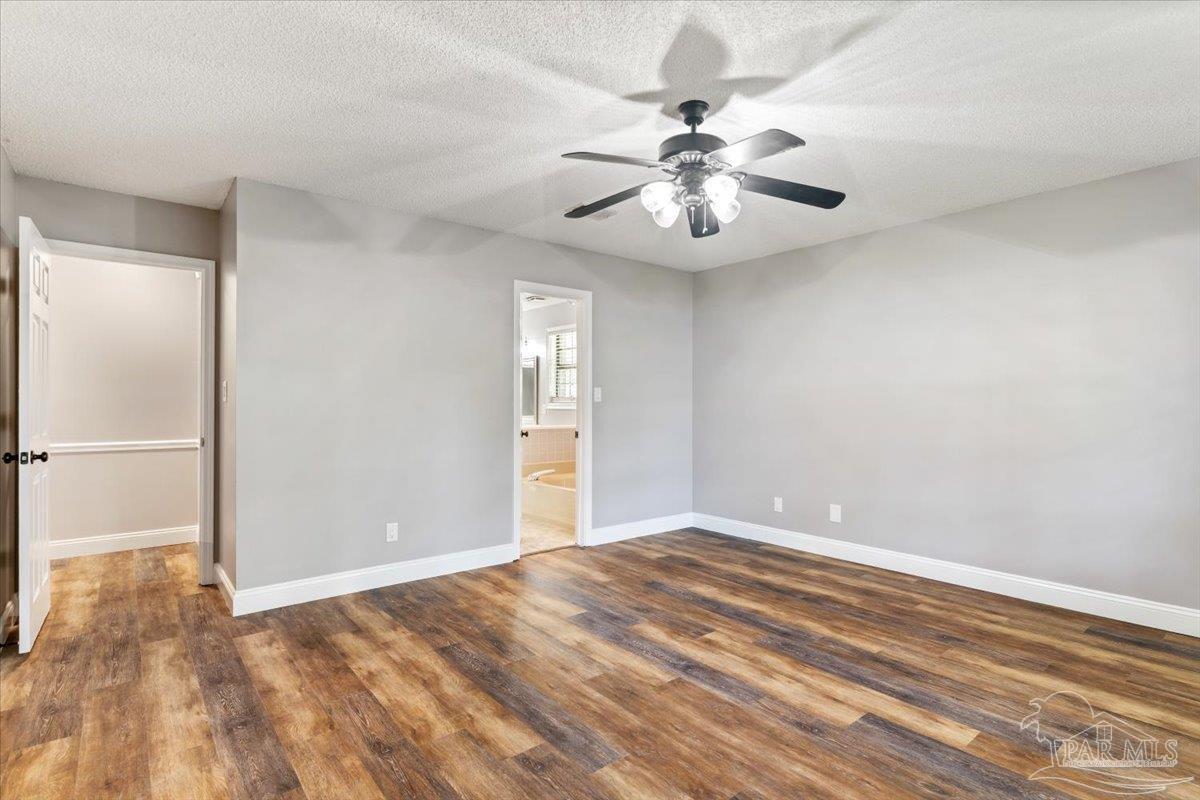 2787 Willow Bend Court Crestview, FL 32539 - Photo 17 of 46 wooden floor in an empty room with a window