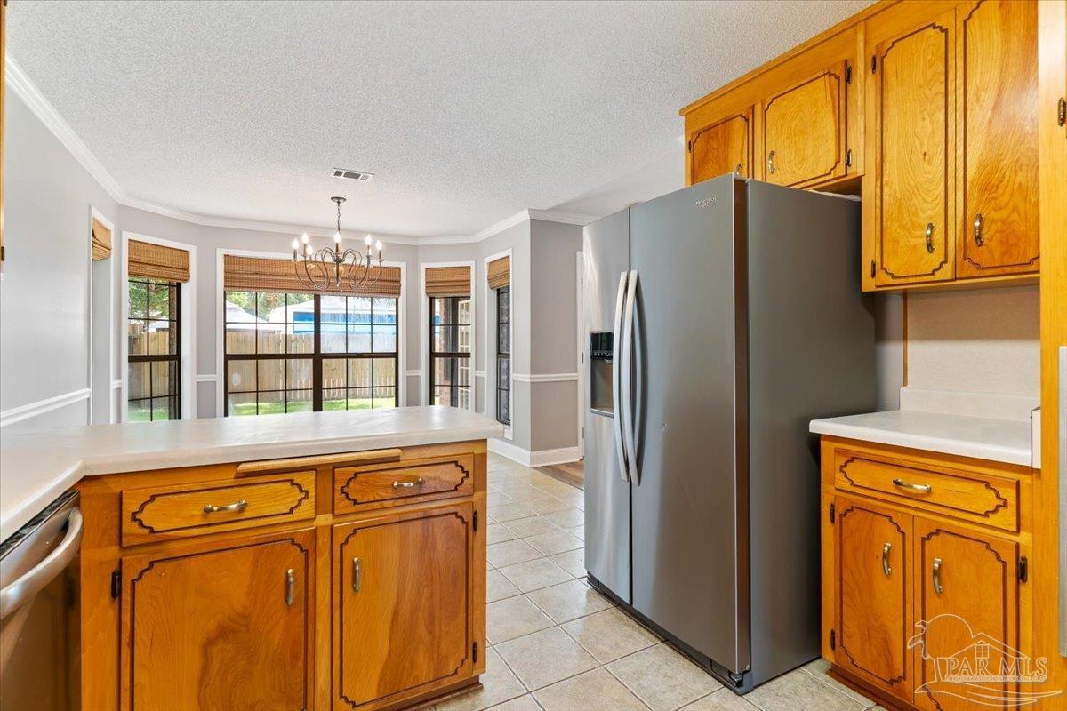 2787 Willow Bend Court Crestview, FL 32539 - Photo 32 of 46 a view of a refrigerator a window and cabinets
