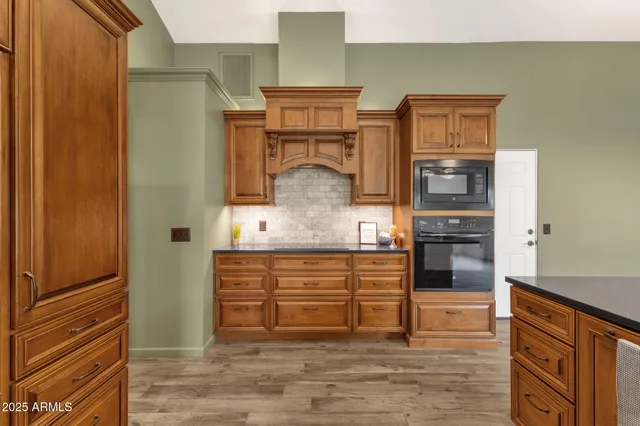 a view of a kitchen with kitchen island a counter space a sink appliances and cabinets