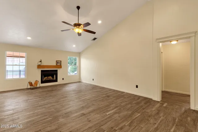 a living room with furniture a fireplace and a chandelier