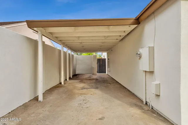 a kitchen with stainless steel appliances granite countertop a sink a counter space and a chandelier
