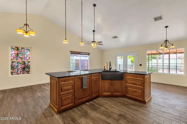 a view of kitchen with stainless steel appliances granite countertop cabinets and stove top oven