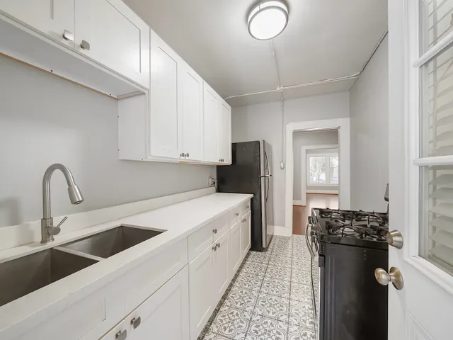 a kitchen with a sink and a refrigerator