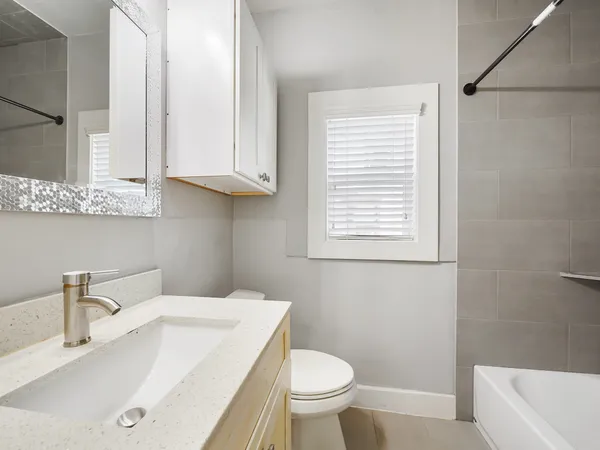 a bathroom with a sink a toilet and bathtub