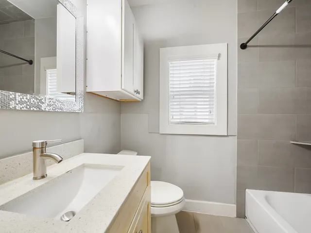 a bathroom with a sink a toilet and bathtub