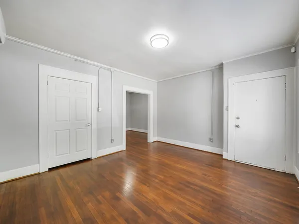 a view of an empty room and wooden floor