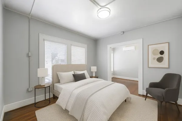 a bedroom with a bed and wooden floor