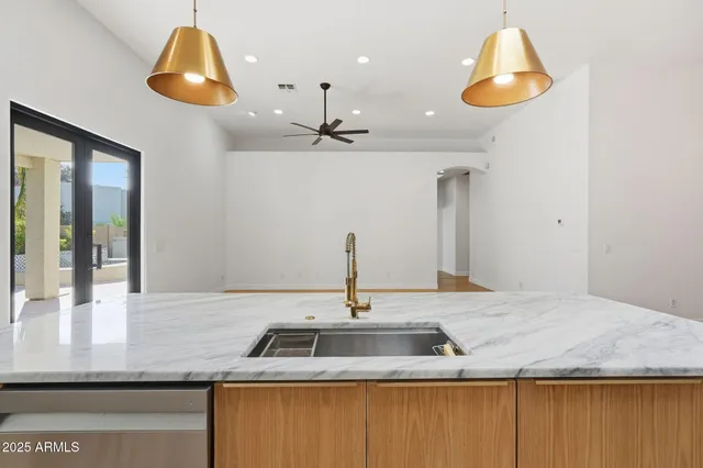 a kitchen with stainless steel appliances a refrigerator sink and microwave