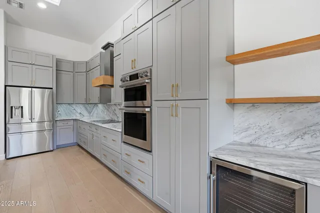 a kitchen with granite countertop cabinets and white appliances