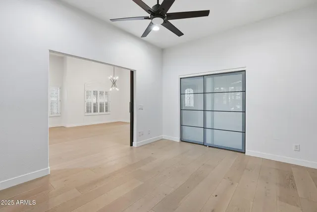 a view of a big room with wooden floor and a window