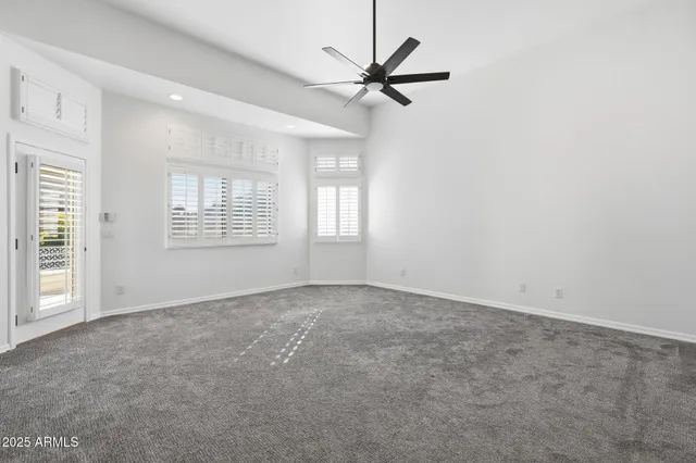 a view of an empty room with a ceiling fan