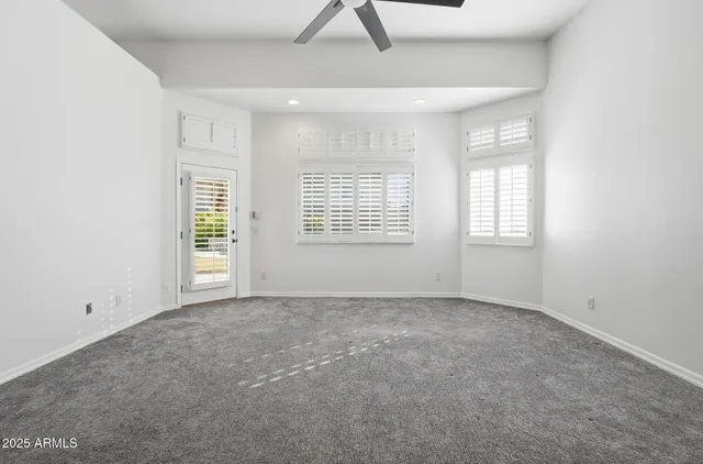 a view of a room with a ceiling fan