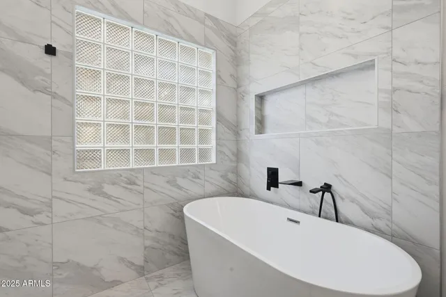 an empty room with a ceiling fan and a window