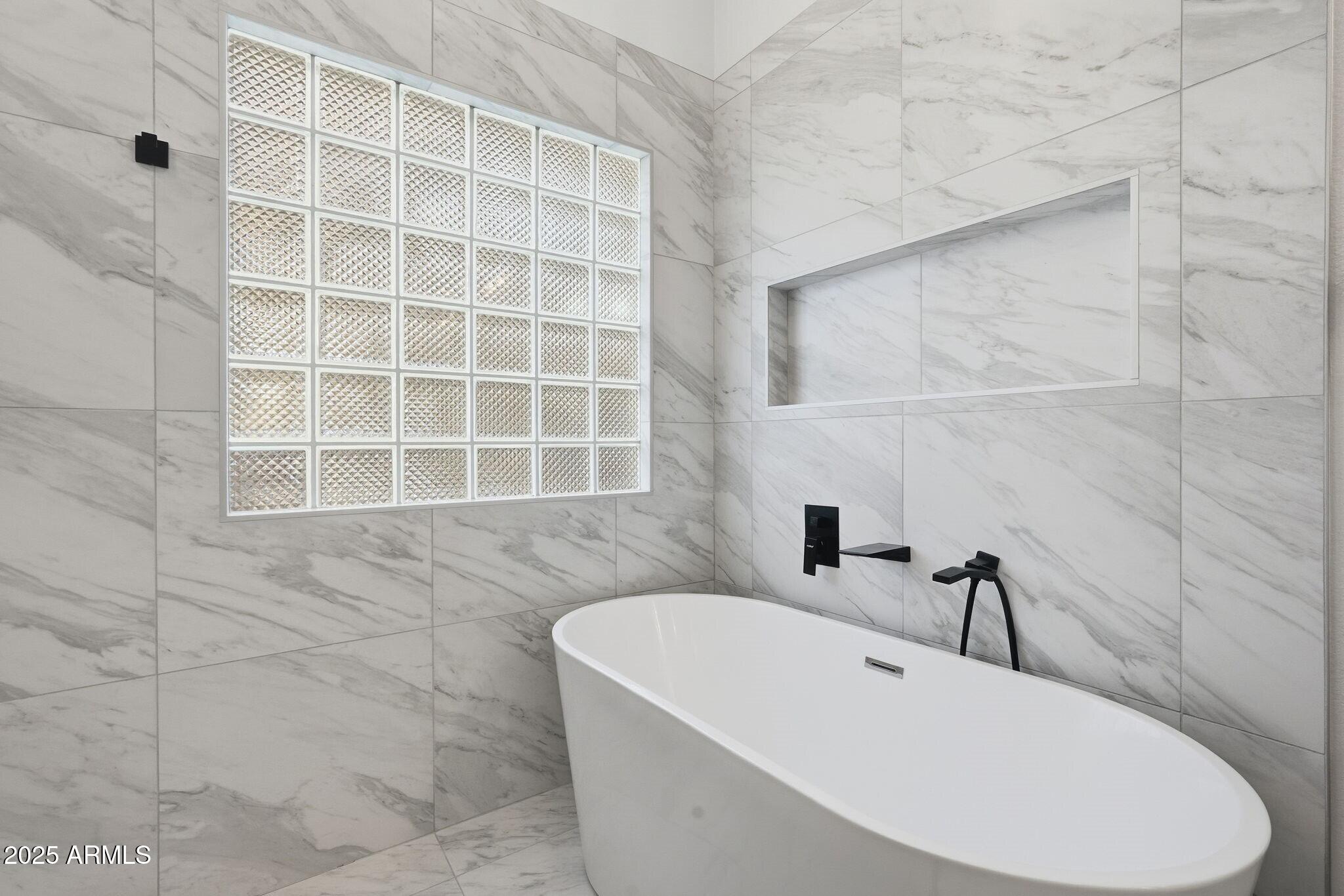 11415 North 44th Street Phoenix, AZ 85028 - Photo 35 of 56 a bathroom with a bathtub and a shower