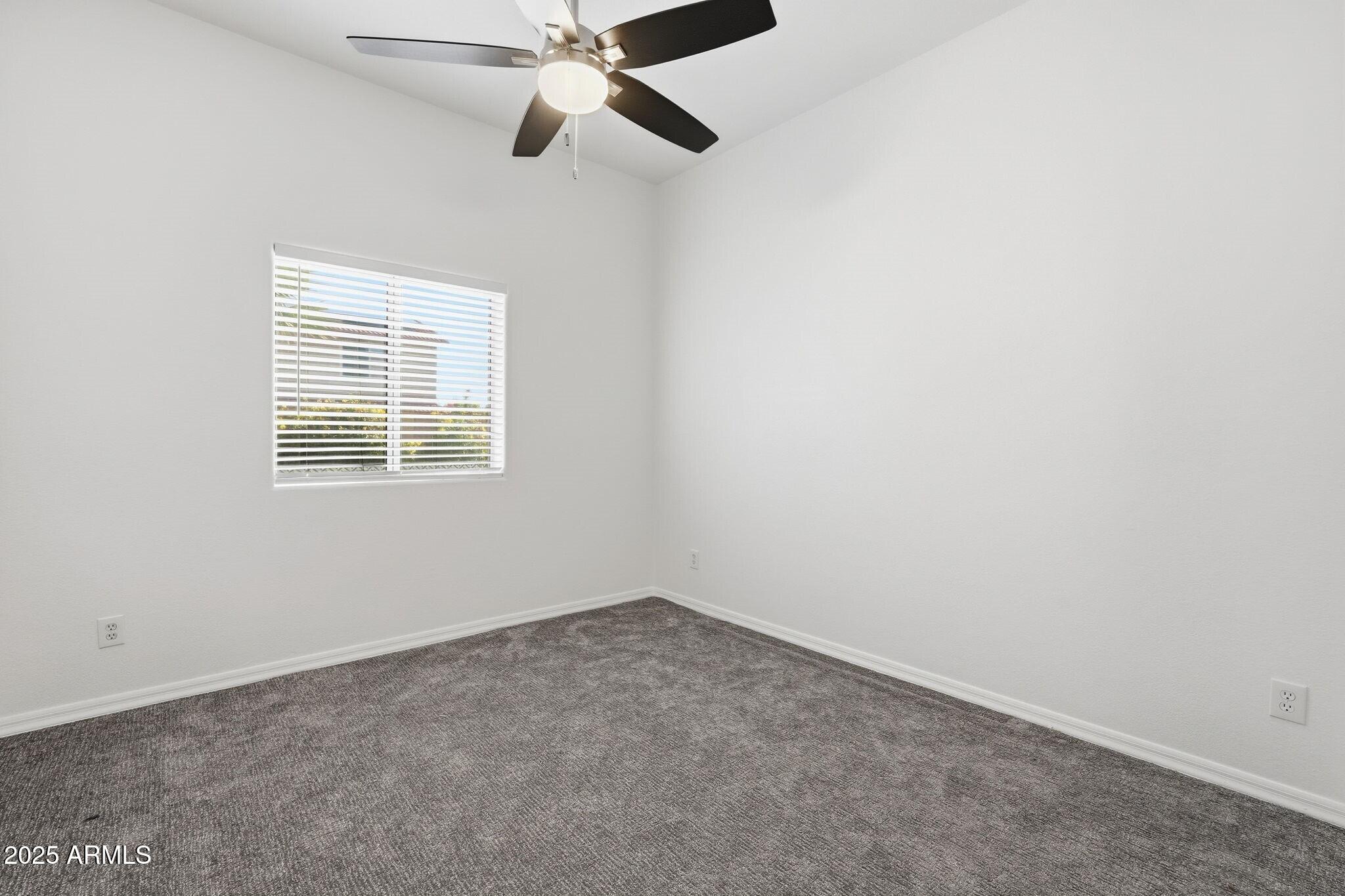 11415 North 44th Street Phoenix, AZ 85028 - Photo 36 of 56 an empty room with a window and a fan