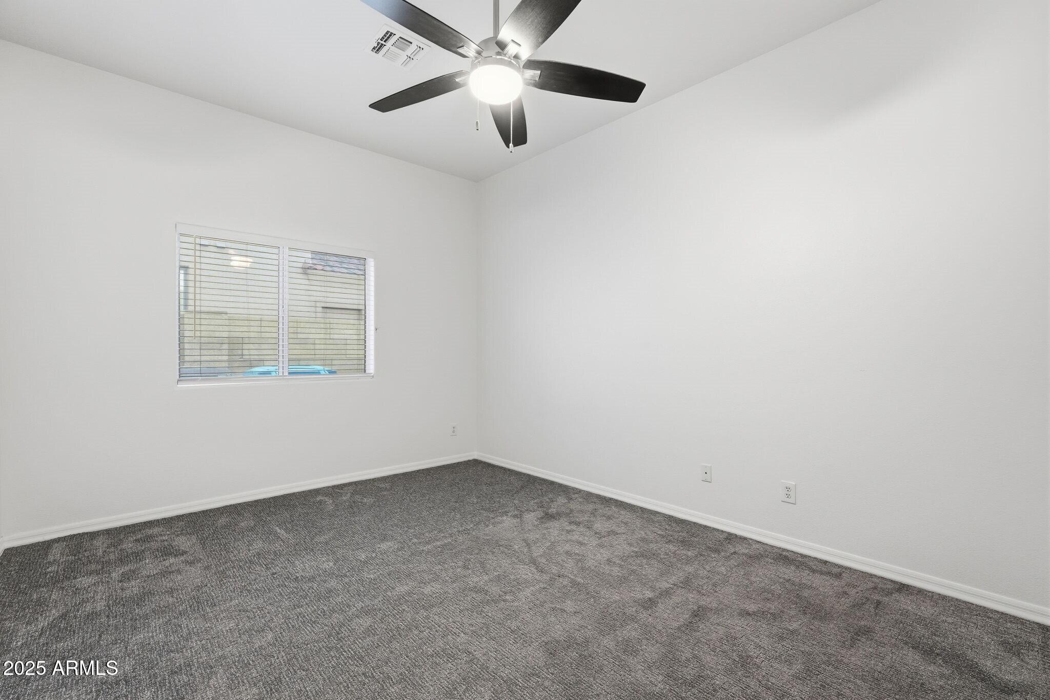 11415 North 44th Street Phoenix, AZ 85028 - Photo 40 of 56 an empty room with a window and a fan