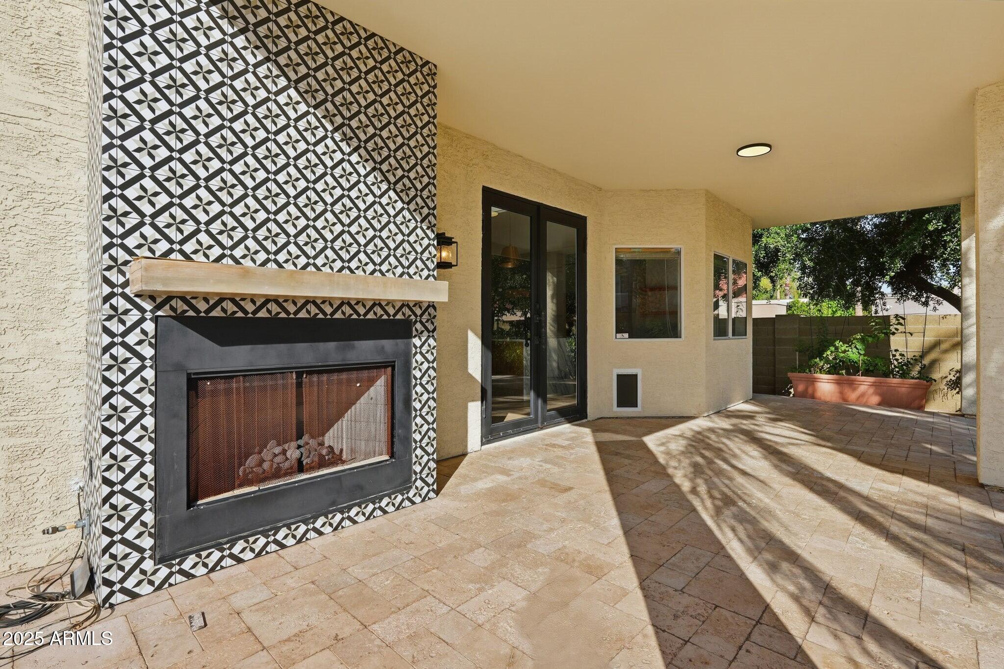 11415 North 44th Street Phoenix, AZ 85028 - Photo 46 of 56 a bedroom with a bed and a fireplace