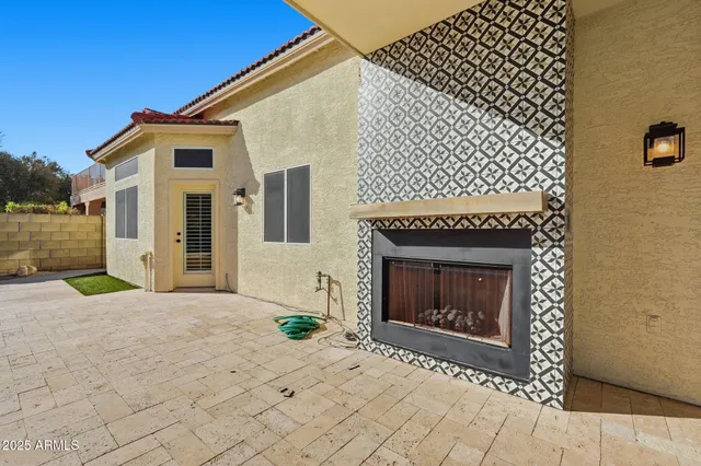 a view of a house with backyard and a tree