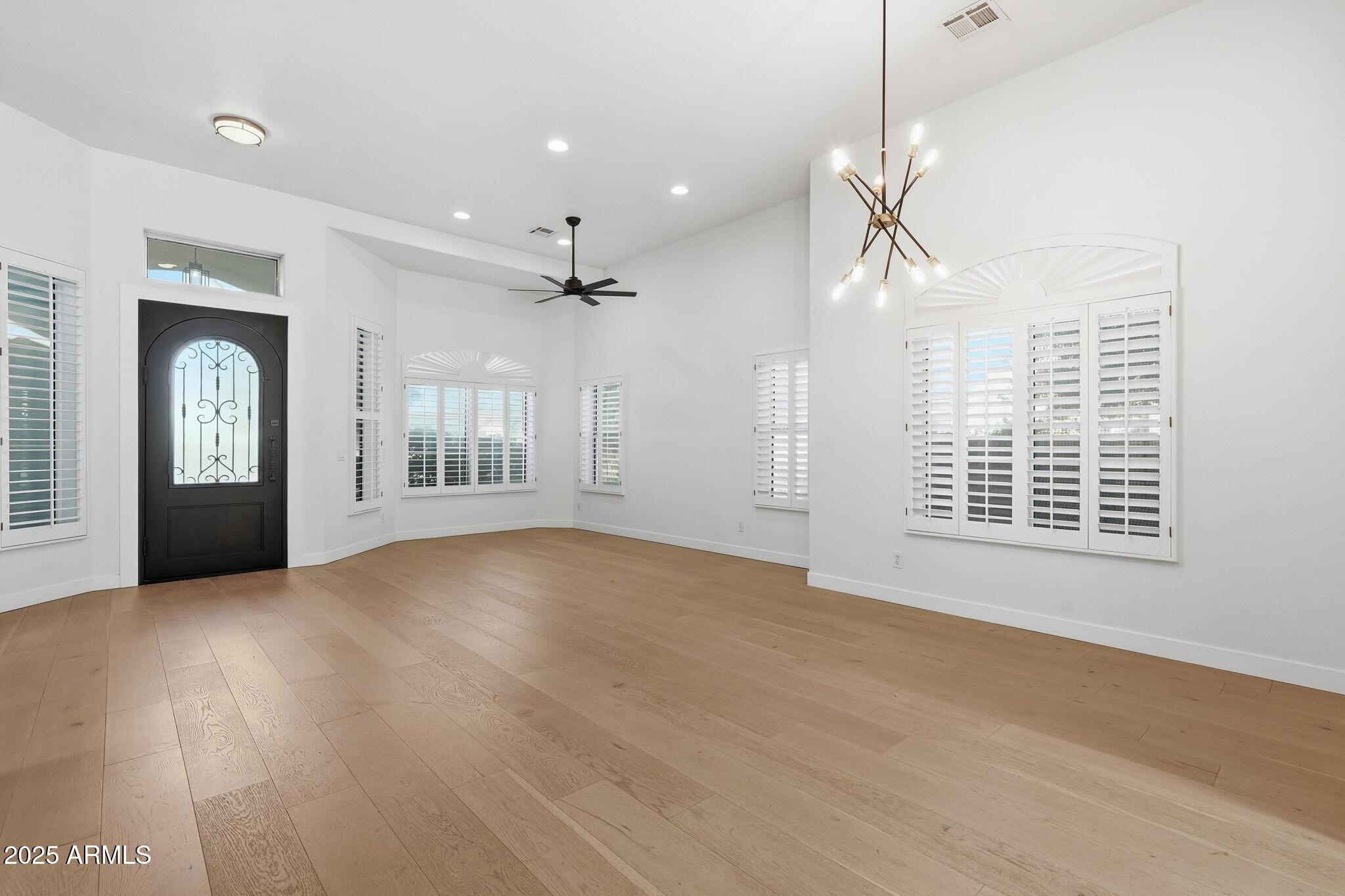 11415 North 44th Street Phoenix, AZ 85028 - Photo 5 of 56 a view of an empty room with chandelier and a window