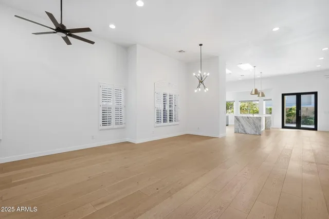 a view of a room with a stylish ceiling fan and entryway
