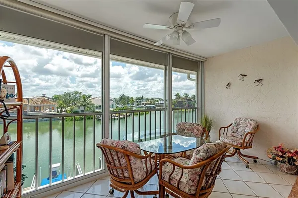a view of a balcony with furniture and a potted plant