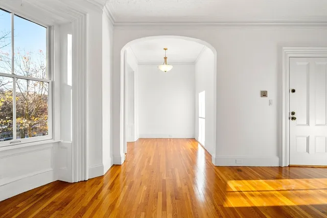 a view of a bedroom with wooden floor and bedroom