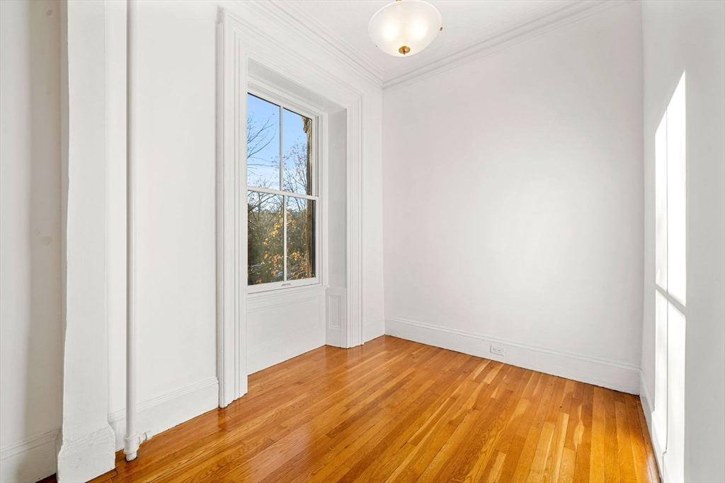 548 Massachusetts Avenue, Unit 3 Boston, MA 02118 - Photo 15 of 28 a view of empty room with wooden floor