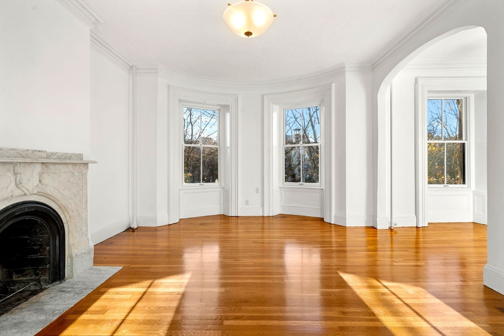 548 Massachusetts Avenue, Unit 3 Boston, MA 02118 - Photo 18 of 28 a view of livingroom with fireplace and window