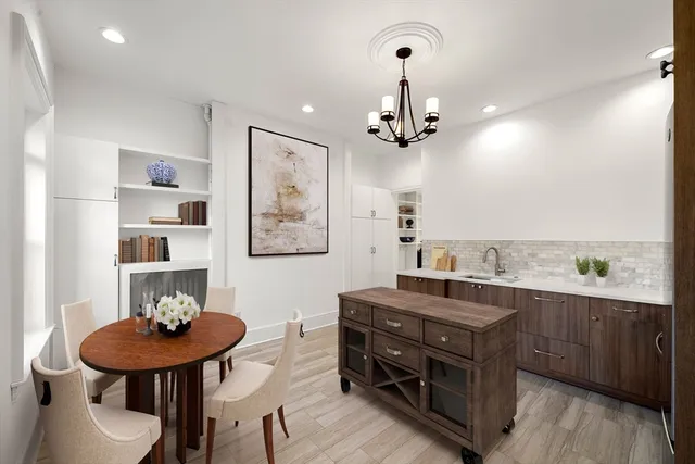 a view of a room with furniture and wooden floor