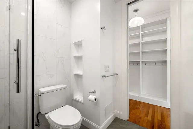 a bathroom with a toilet and a shower