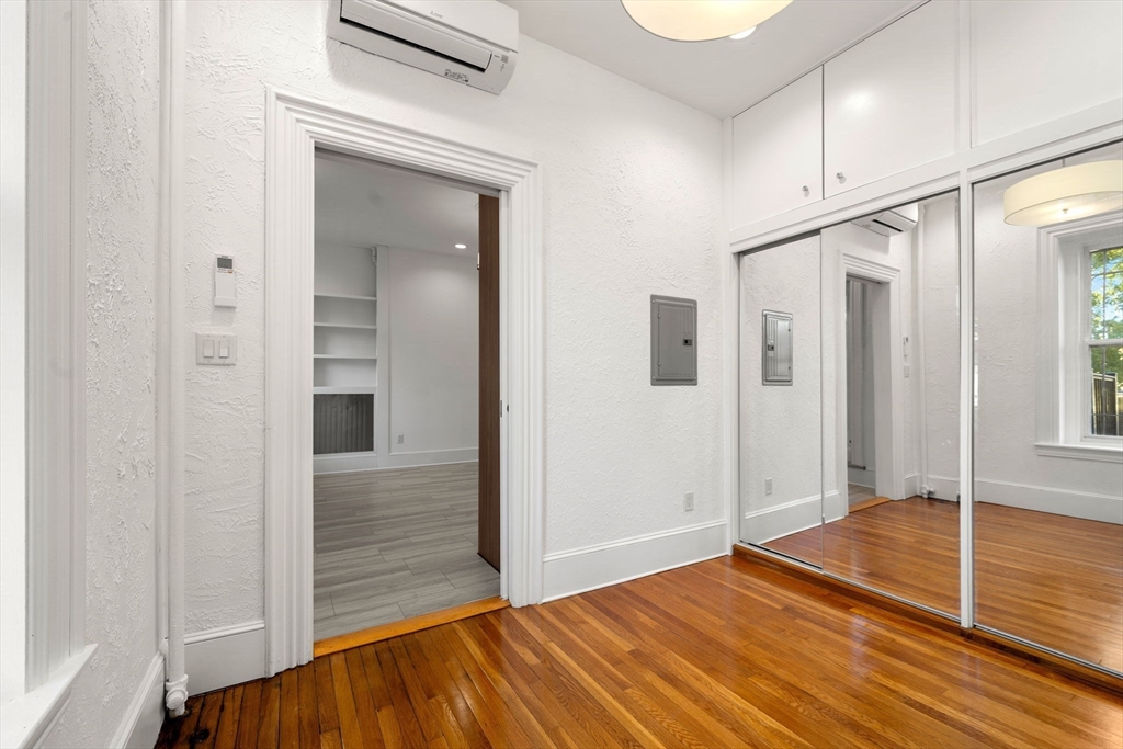 548 Massachusetts Avenue, Unit 3 Boston, MA 02118 - Photo 22 of 28 a view of a hallway with wooden floor and staircase