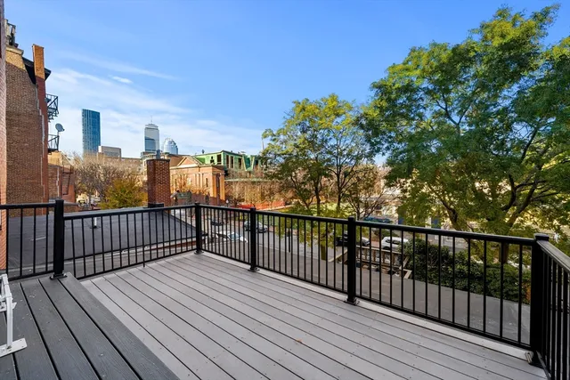 a view of a balcony with wooden floor and fence