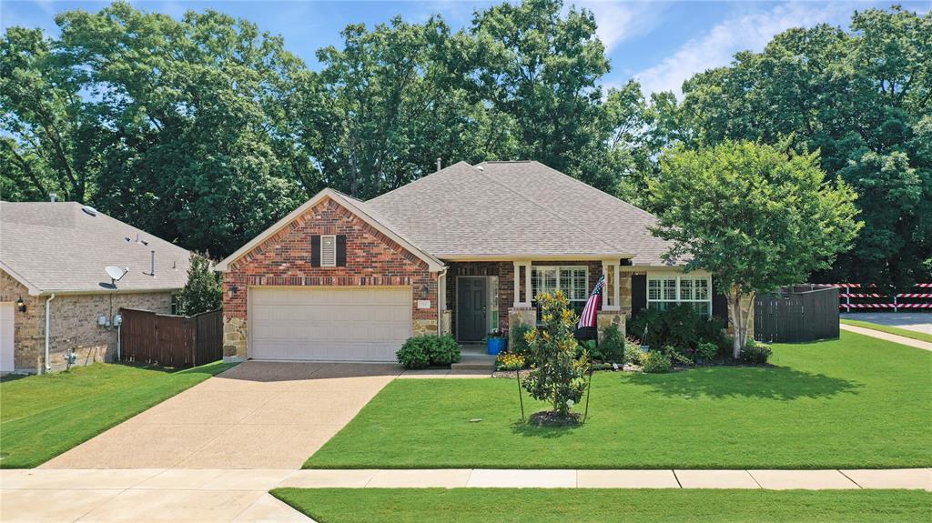 700 Peterhouse Drive McKinney, TX 75071 - Photo 1 of 1 a front view of a house with garden