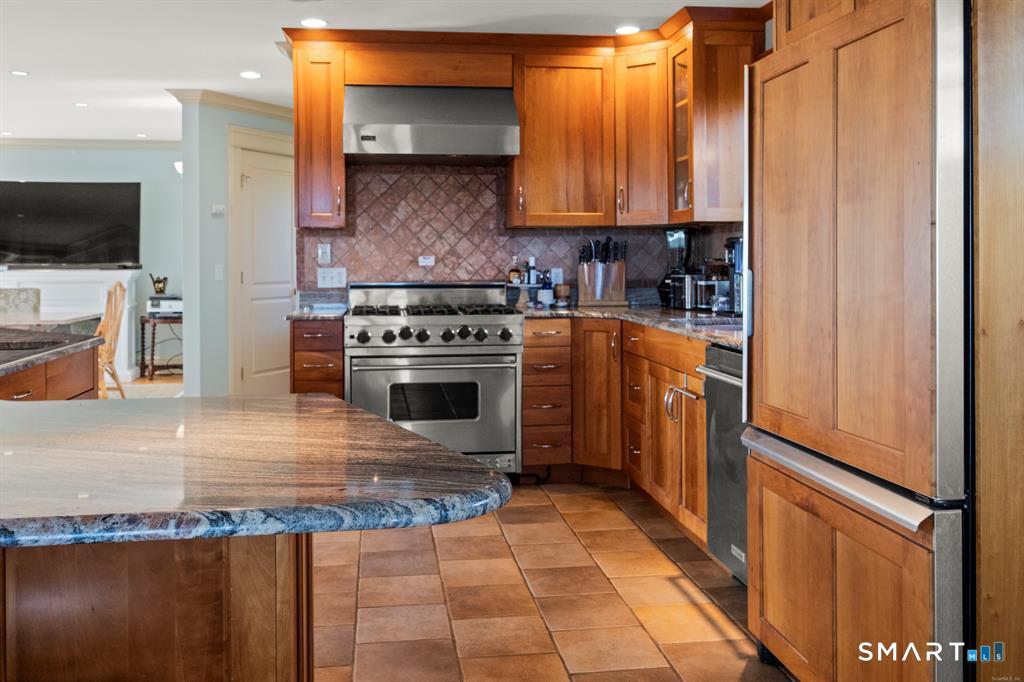 4 Point Road Old Saybrook, CT 06475 - Photo 17 of 58 a kitchen with stainless steel appliances granite countertop a stove a sink and a microwave