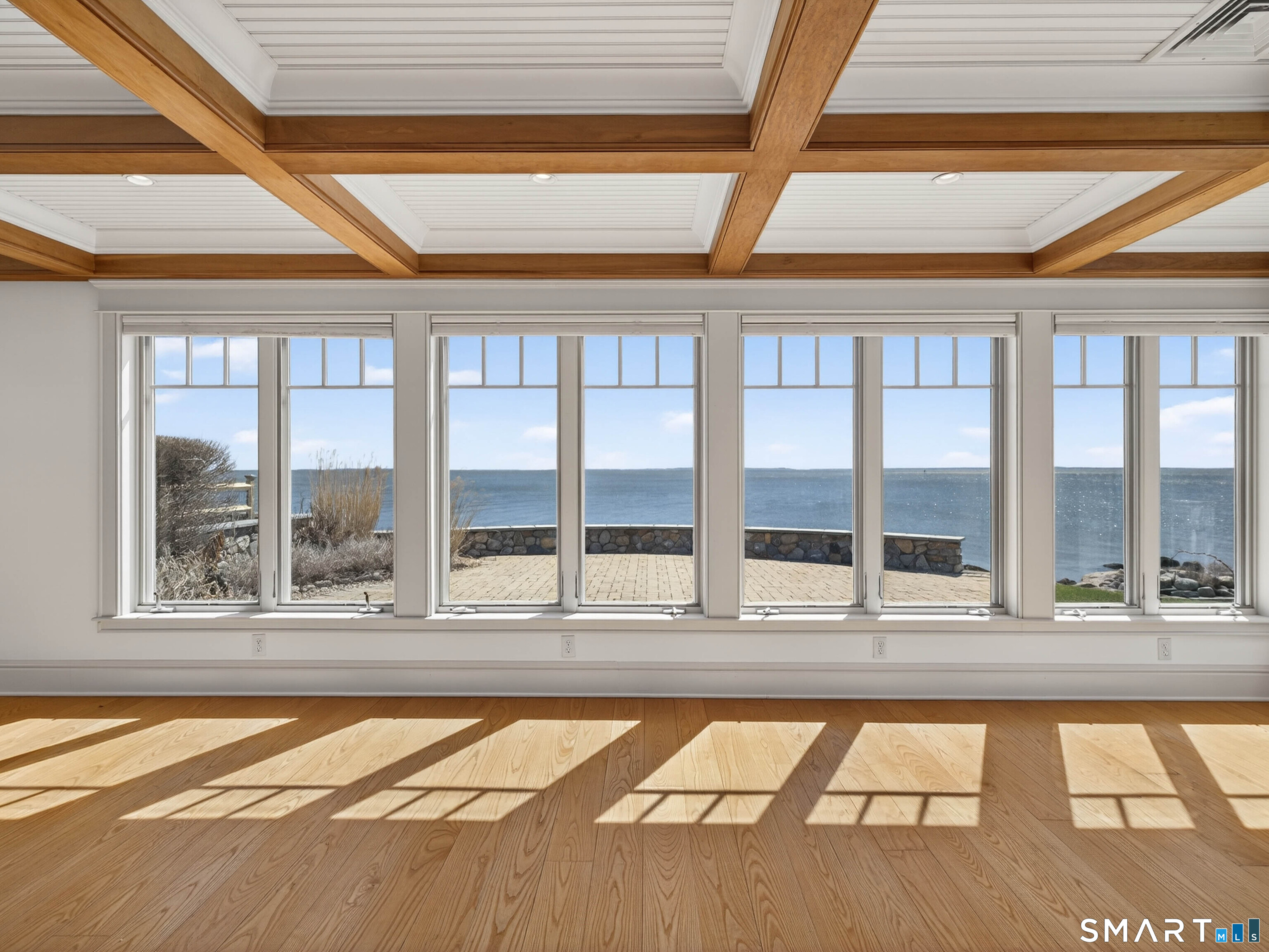4 Point Road Old Saybrook, CT 06475 - Photo 22 of 58 a view of an empty room with wooden floor and a floor to ceiling window