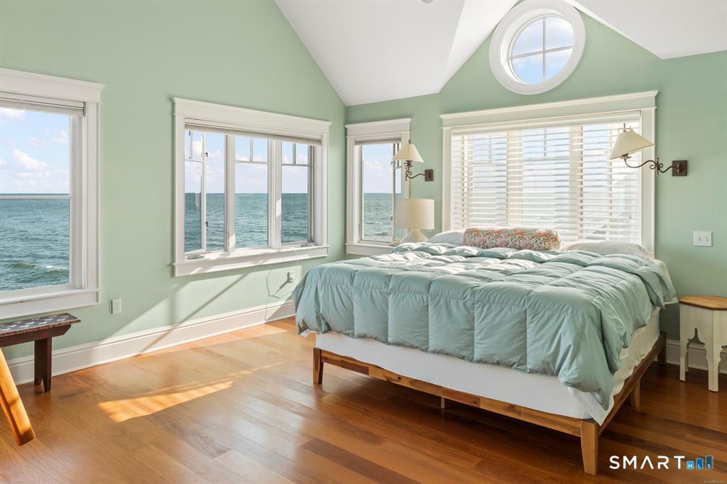 4 Point Road Old Saybrook, CT 06475 - Photo 25 of 58 a bed sitting in a bedroom next to a window