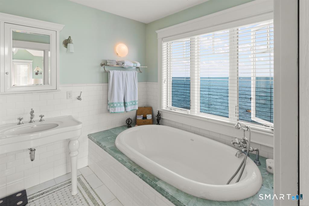 4 Point Road Old Saybrook, CT 06475 - Photo 29 of 58 a bathroom with a granite countertop tub sink and mirror