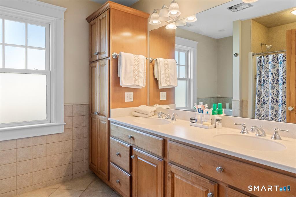 4 Point Road Old Saybrook, CT 06475 - Photo 35 of 58 a bathroom with a double vanity sink mirror and double