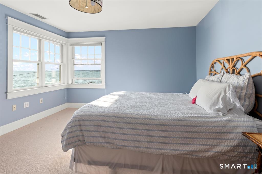 4 Point Road Old Saybrook, CT 06475 - Photo 37 of 58 a bedroom with a bed and a window