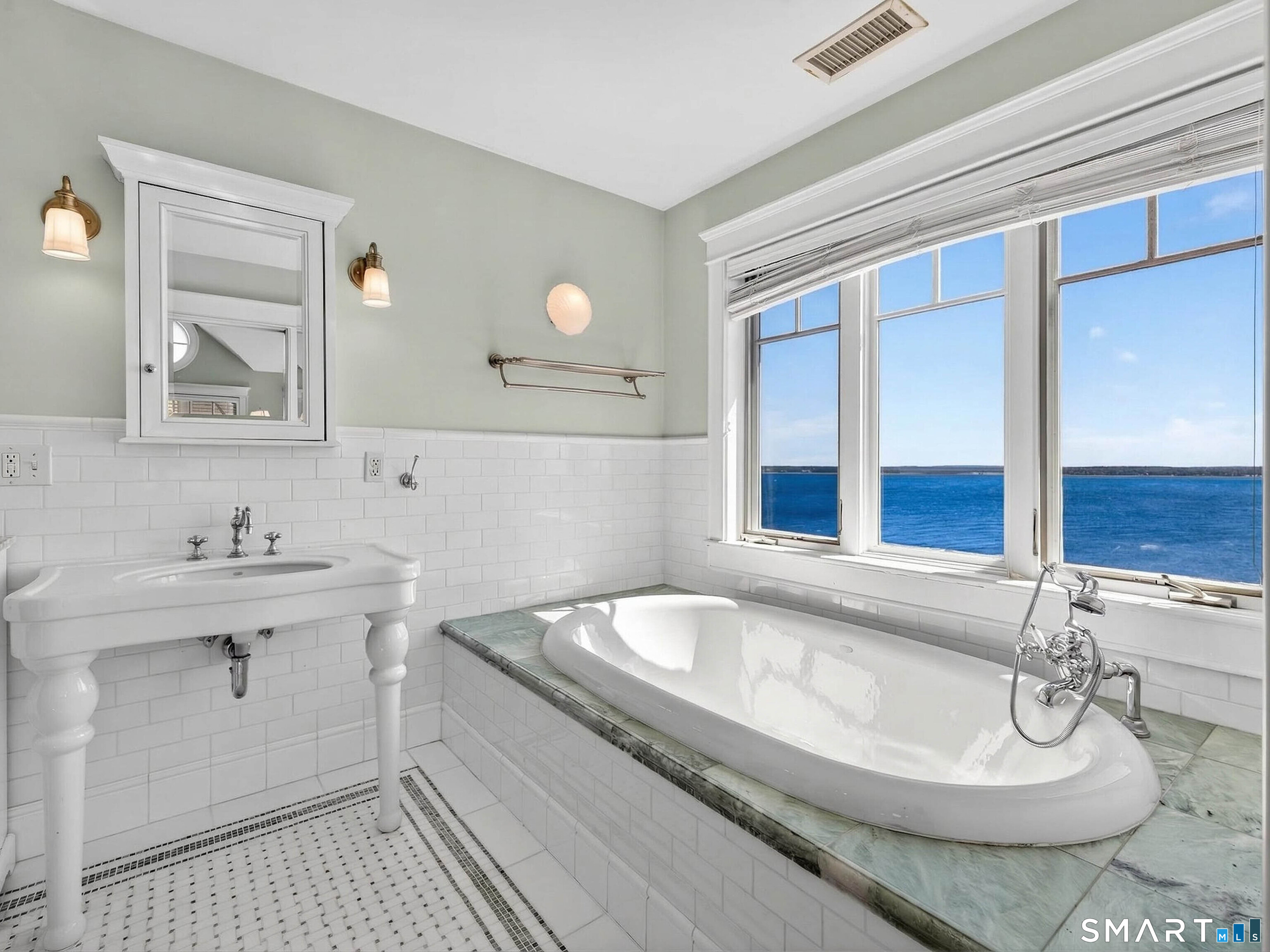 4 Point Road Old Saybrook, CT 06475 - Photo 40 of 58 a bathroom with a tub sink and mirror