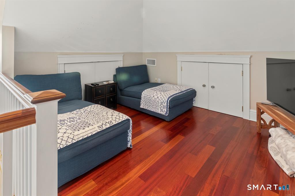 4 Point Road Old Saybrook, CT 06475 - Photo 43 of 58 a bedroom with two beds and a flat screen tv