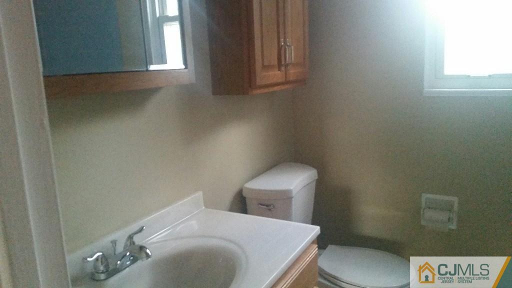 23 Wilshire Road Edison, NJ 08817 - Photo 15 of 21 a bathroom with a toilet a sink and a window